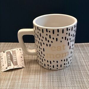 “Cat Mom" mug features a cat figurine inside.